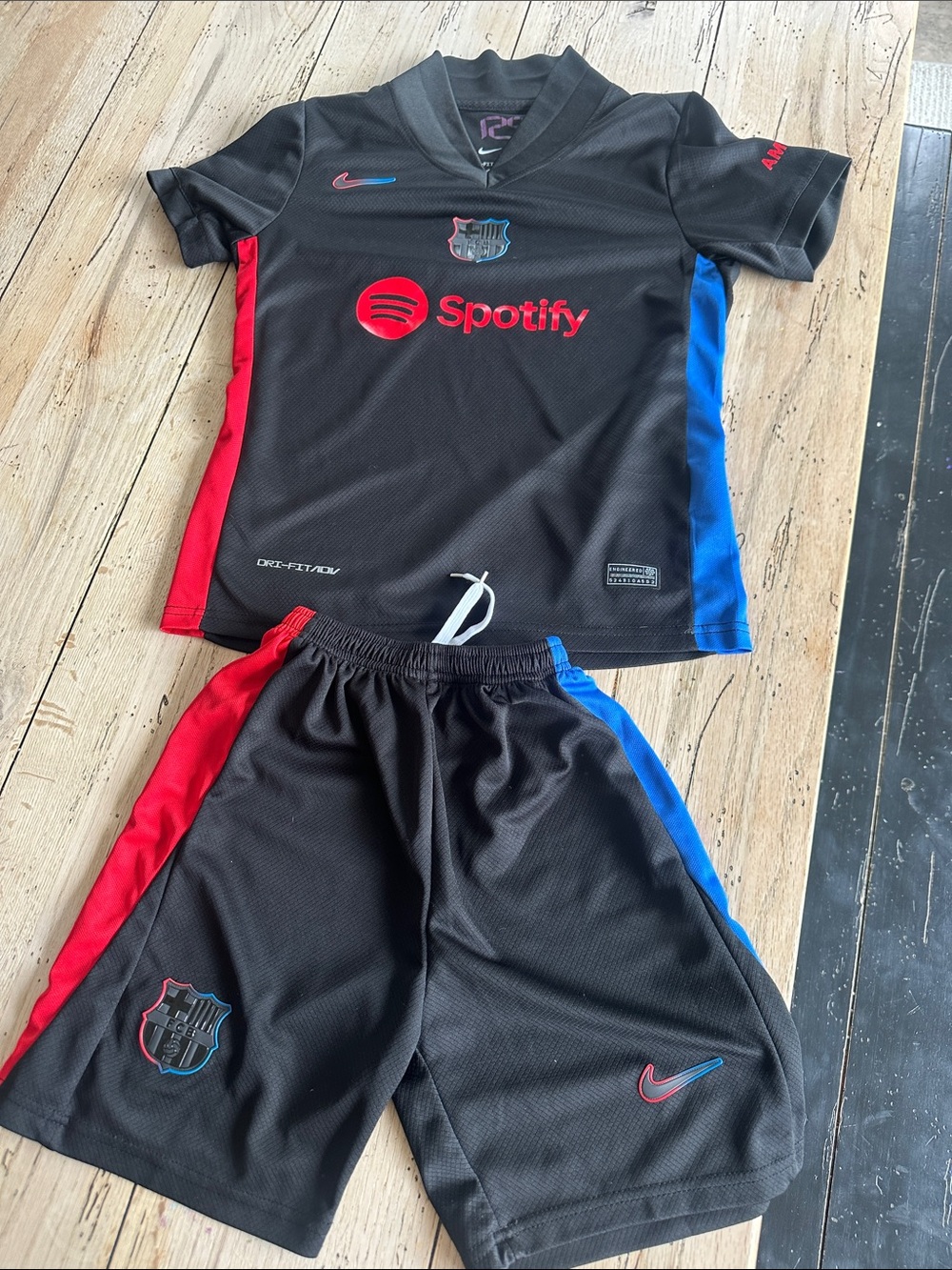 Nike Kids Black Jersey and Shorts Set with Red & Blue Accents